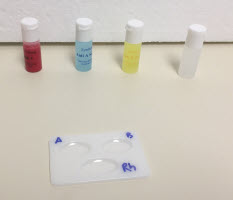 empty blood well with blood samples and serums behind it.